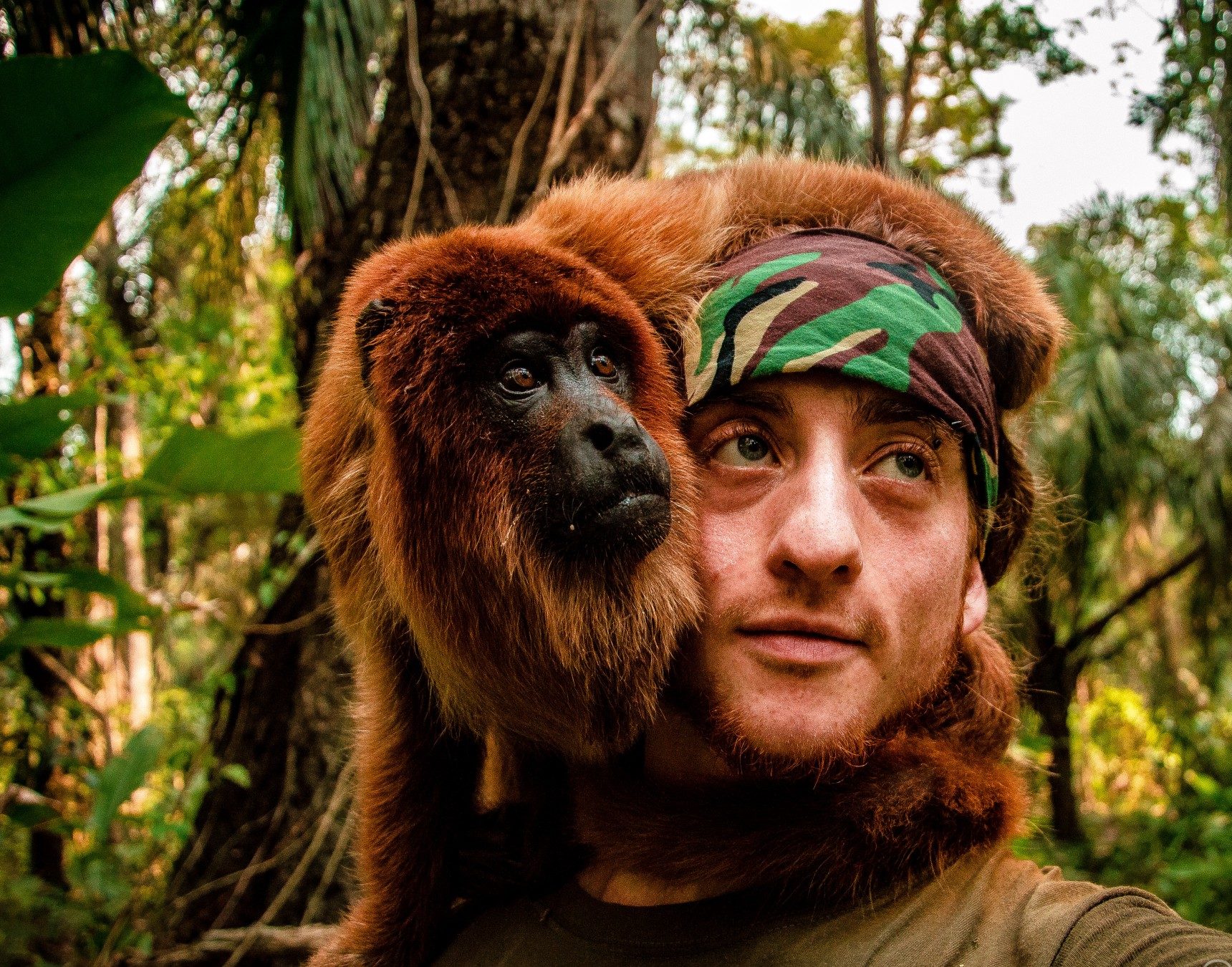 Raphaël Coleman in the jungle with a monkey