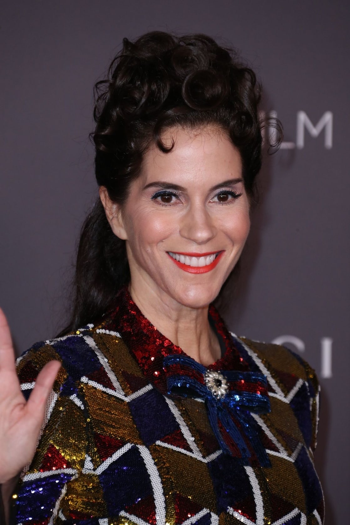 jami gertz smiles and waves at the 2017 LACMA Art and Film Gala in Los Angeles