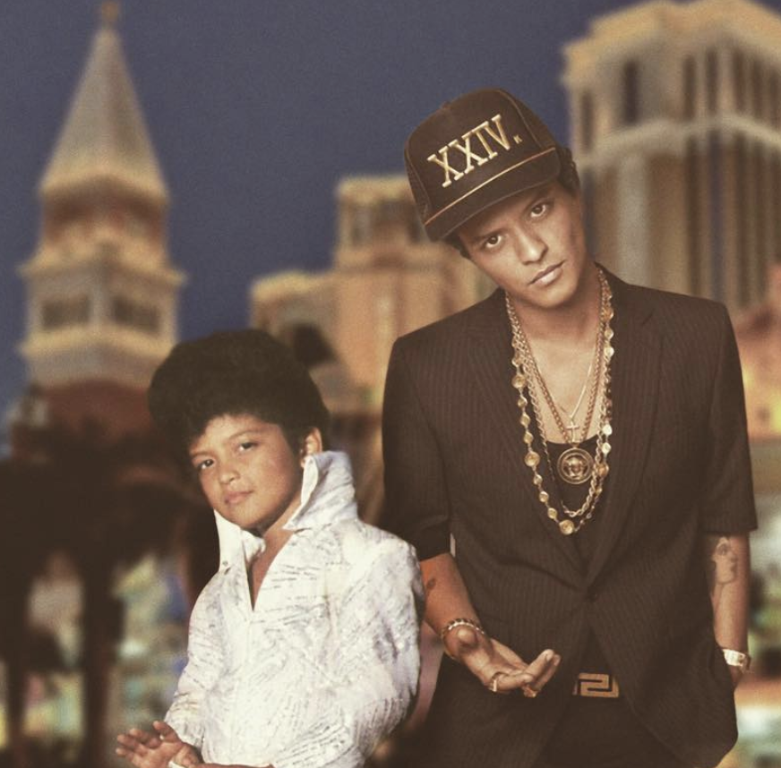 bruno mars posing next to a picture of himself