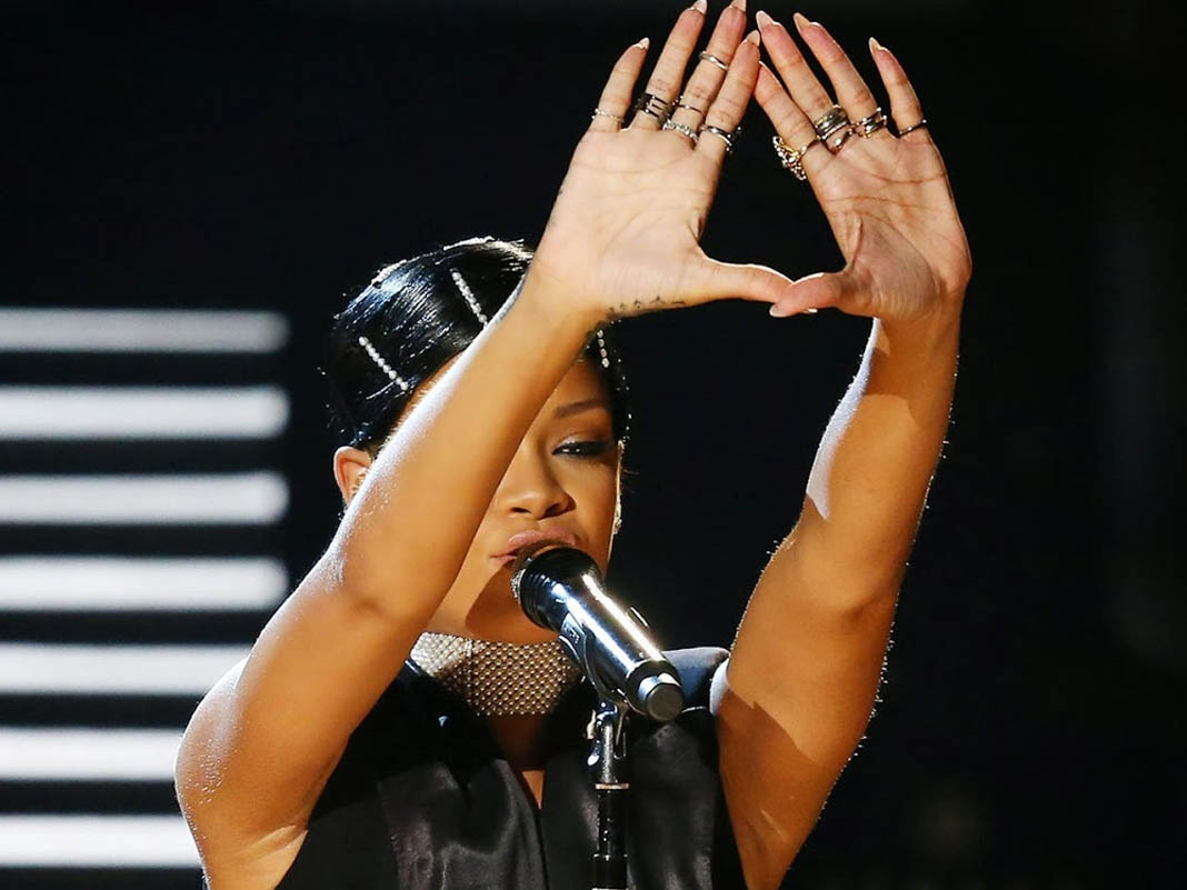 rihanna doing an illuminati sign