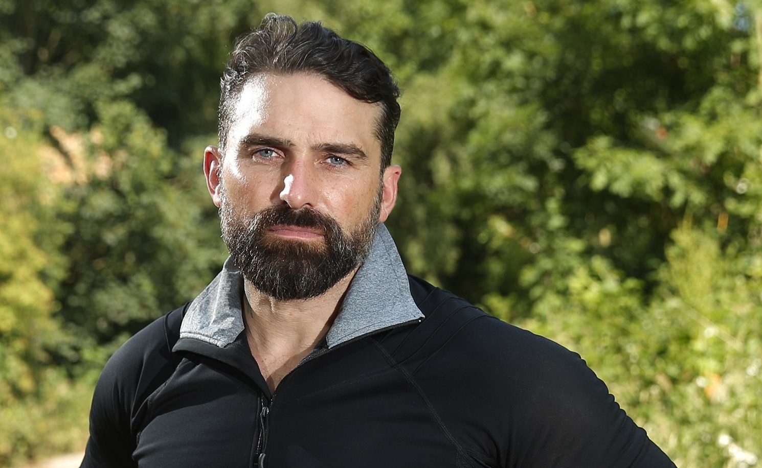 Ant Middleton net worth posing for a photo in a forest