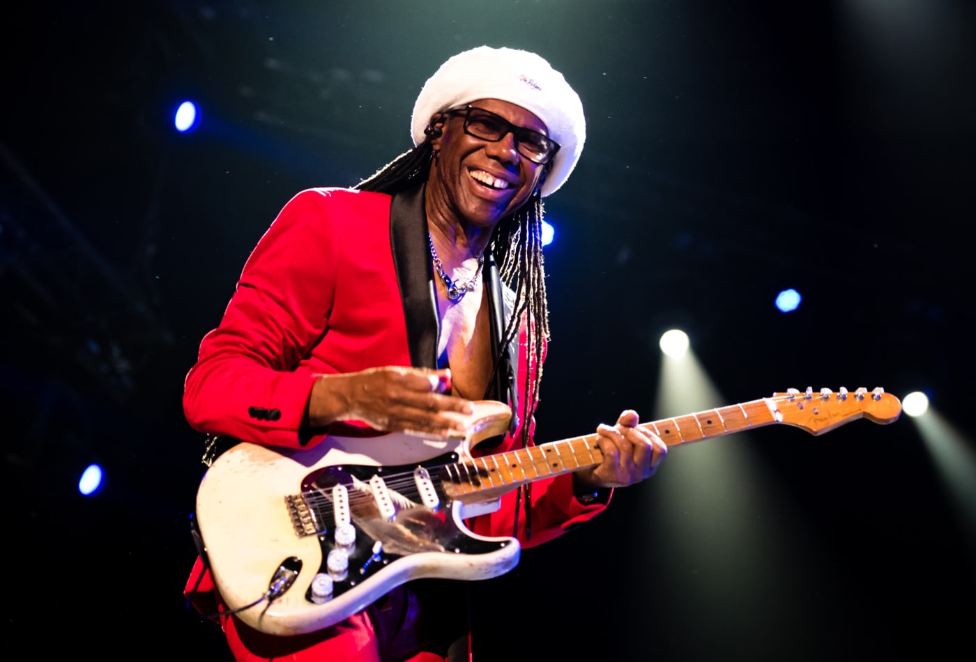 Nile Rodgers net worth playing guitar on stage