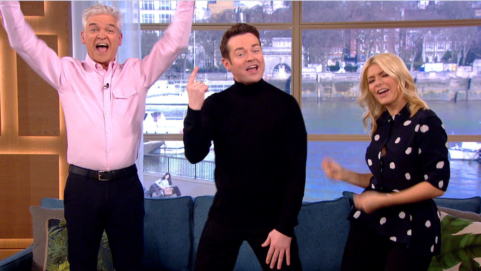 Phillip Schofield and Holly Willoughby surround our friend on the set of This Morning.