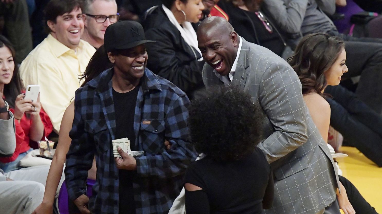 Denzel Washington (pictured with former Lakers great Magic Johnson) is one of a host of celebrity fans of the storied NBA franchise