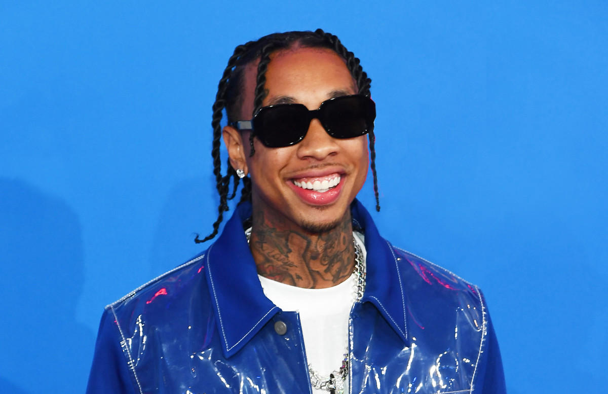 Tyga net worth - posing for a photo on the red carpet