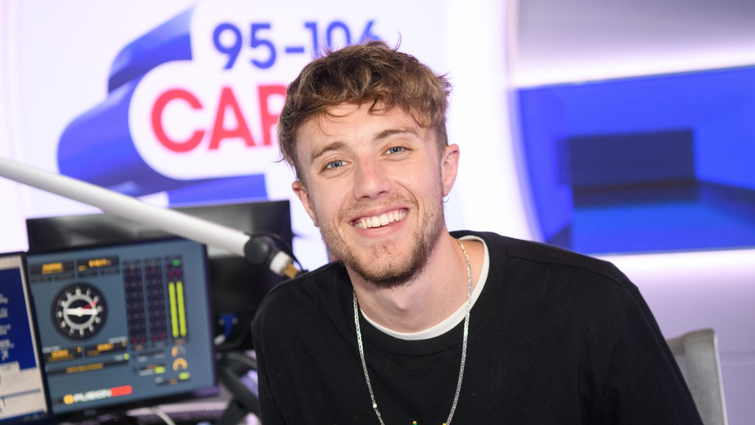 Roman Kemp age - posing at his radio station