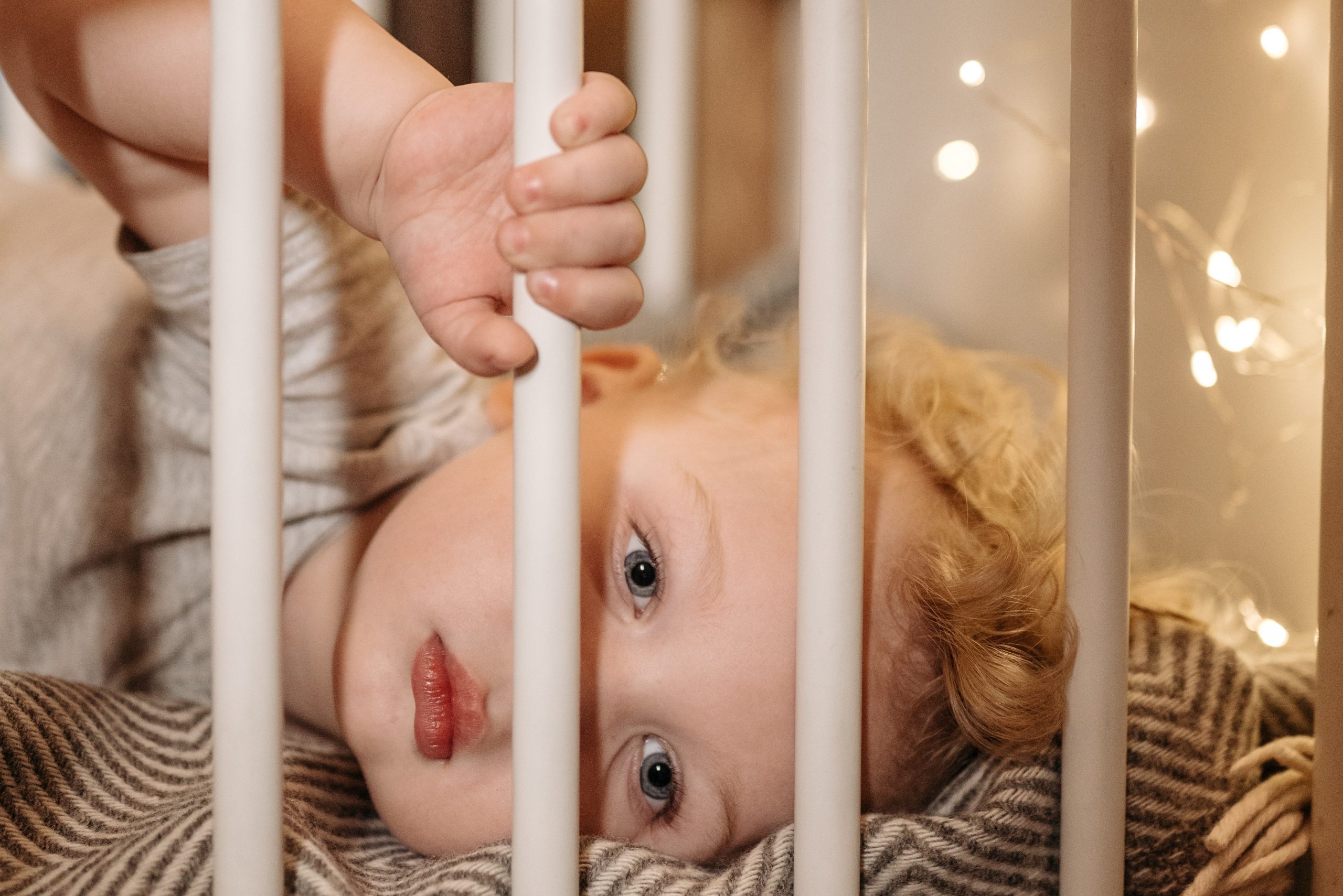 Blonde Girl in Crib