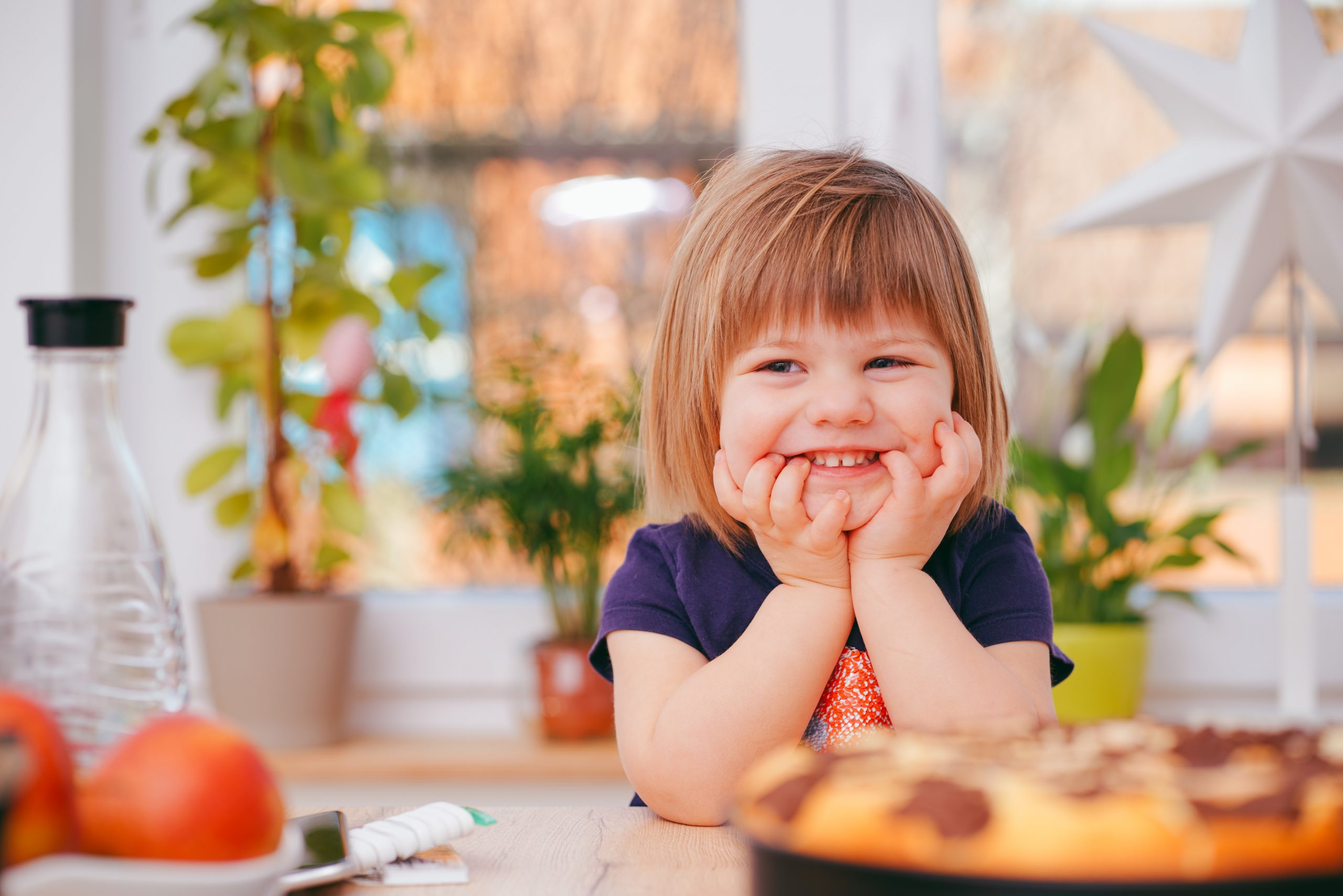 Little Girl Sat at Table