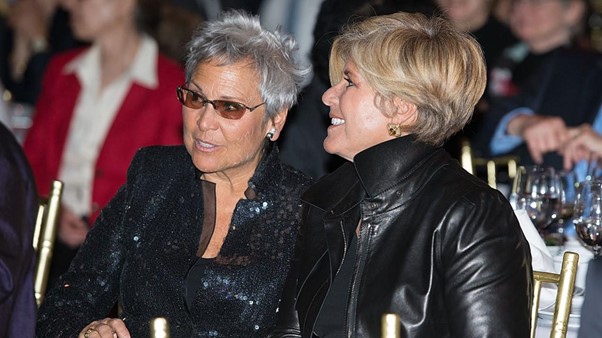 Kathy Travis and Suze Orman attend a business event.