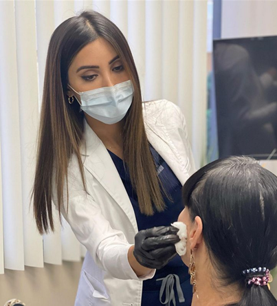 Fay Asghari in action at her cosmetic treatment practice.